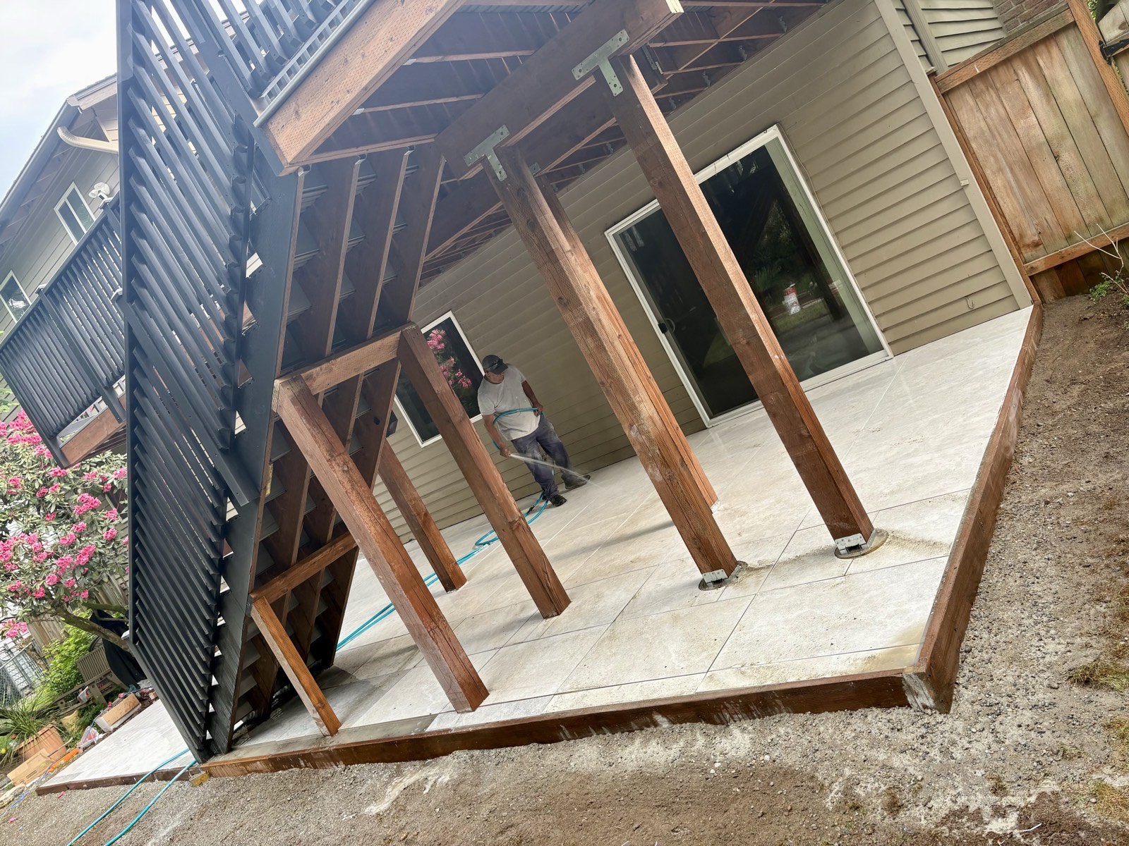 Elevated deck framing over patio